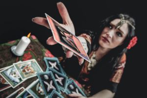 woman holding a book and a lighted candle