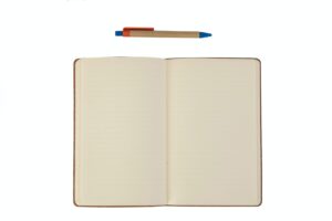 white book with blue pen