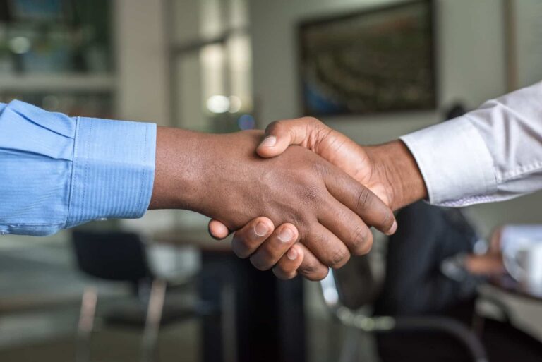 two people shaking hands after sale